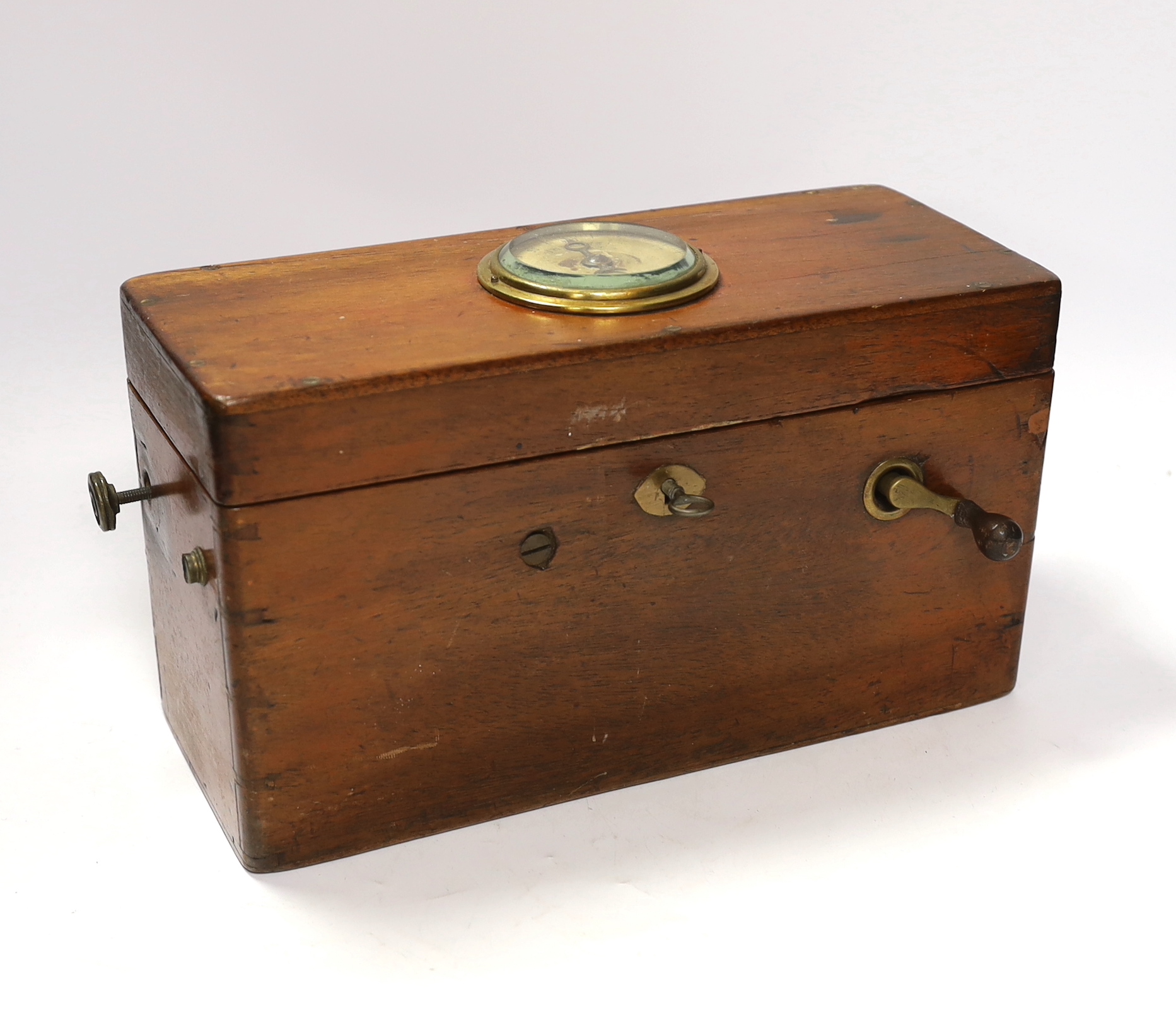 A Magneto electric shock machine in a mahogany case with output gauge to lid and built-in drawer containing a range of alternative fittings and implements with ebonised handles, lock with original key, 16.5cm high, 30cm